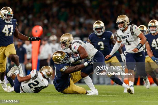 Daba Fofana of Navy Midshipmen is tackled during the Aer Lingus College Football Classic match between Notre Dame and Navy at Aviva Stadium on August...