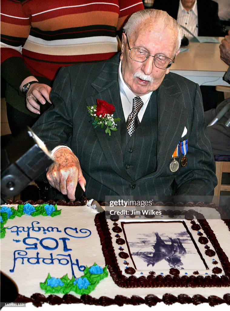 VET 105 1 / 02/26/06 -- Dwight Wilson cuts into the cake as he marks his 105th birthday at Oshawa's 