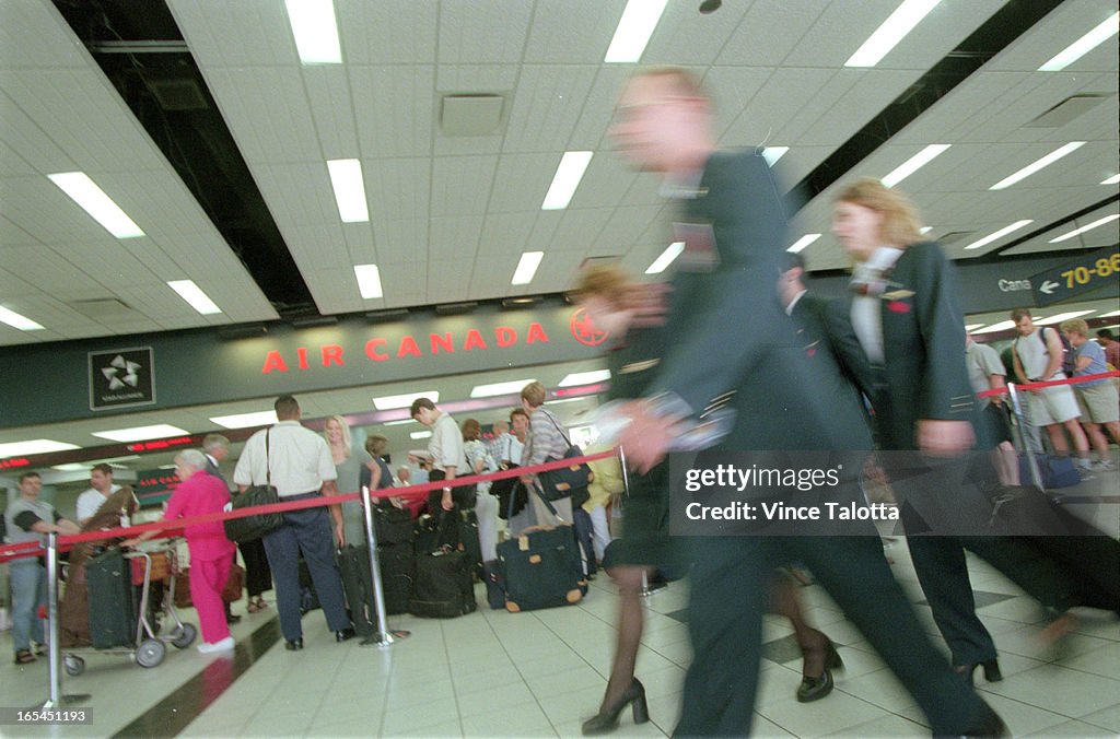 Pics of travellers in line at Air Canada deaparture area,travellers and people looking at departure 