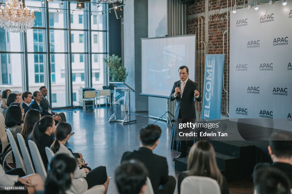 Asian mature businessman coaching, motivation speech in business conference meeting seminar during convention center