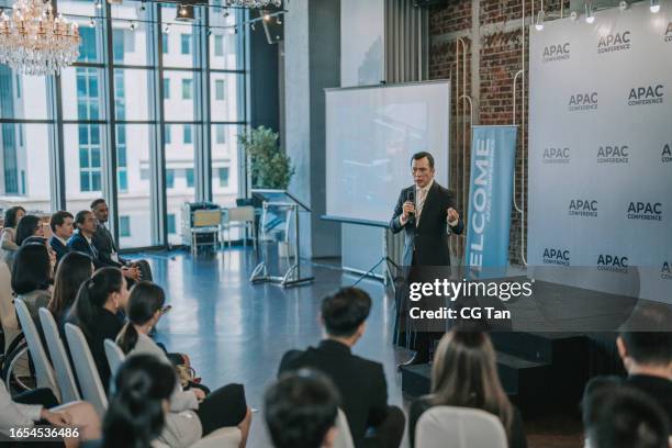 asian mature businessman coaching, motivation speech in business conference meeting seminar during convention center - caixa de som imagens e fotografias de stock