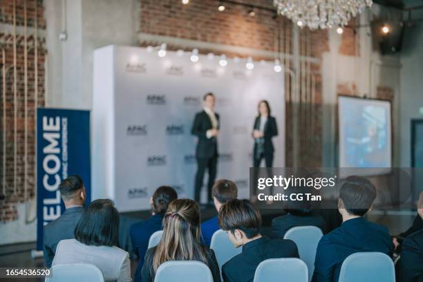 back view active asian seminar participant attending business conference sharing session - business conference stock pictures, royalty-free photos & images