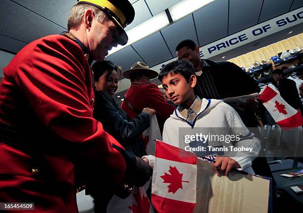 October 20, 2010-Toronto Maple Leafs fan, Akashdeep Nandy seems a bit in awe as he shakes the hand of RCMP Inspector Steve Saunders during his...
