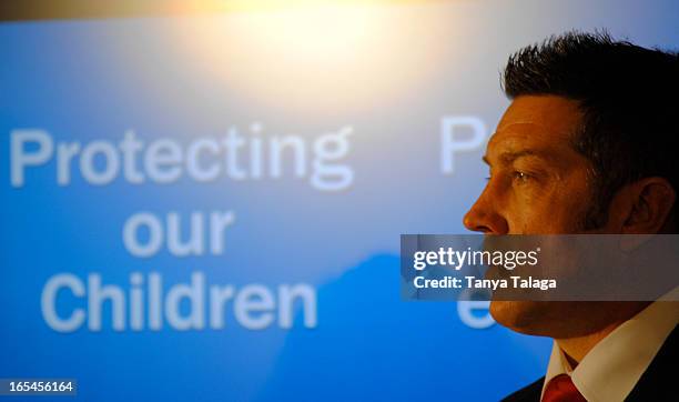 Former hockey player Sheldon Kennedy listens to the unveiling of new legislation to protect children from sexual predators at a Toronto press...