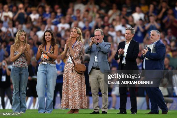 Gianluca Vialli's wife Cathryn and daughters Olivia and Sofia applaud before the Legends football match between Chelsea and Bayern Munich at Stamford...