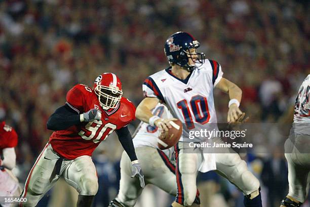 Robert Geathers of Georgia applies pressure to Quarterback Eli Manning of Mississippi during the SEC game between on November 9, 2002 at Sanford...