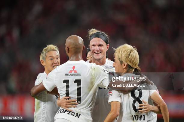 Of Urawa Reds celebrates scoring his side's first goal with his team mates during the J.LEAGUE Meiji Yasuda J1 26th Sec. Match between Albirex...