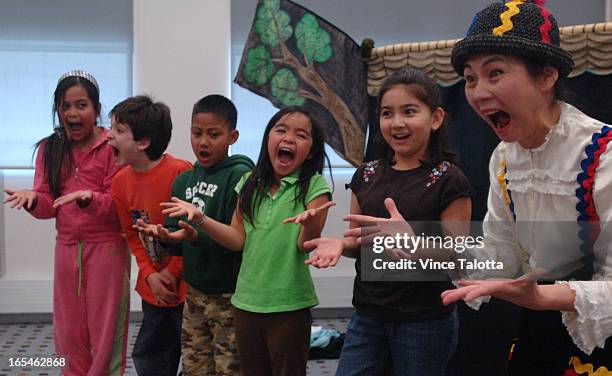 Silent Storyteller Noriko Yamamoto performs for the children with the help of from left to right- Krisel Capua,10 yrs in pink,Zeyian Melo,8 in...