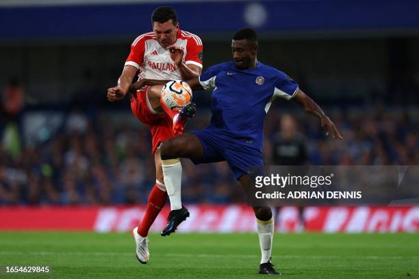 Chelsea legend Salomon Kalou vies with Bayern legend Lucio during the Legends football match between Chelsea and Bayern Munich at Stamford Bridge in...
