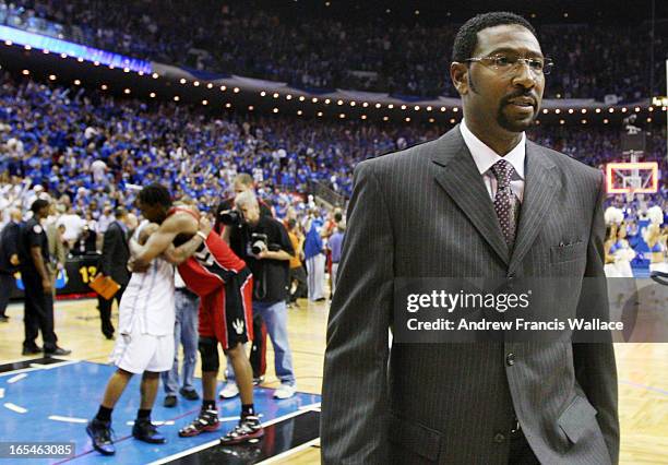 Toronto Raptors head coach Sam Mitchell leaves the court as Chris Bosh congratulates Orlando Magic Jameer Nelson after 102-92 Magic win in Game 5 of...