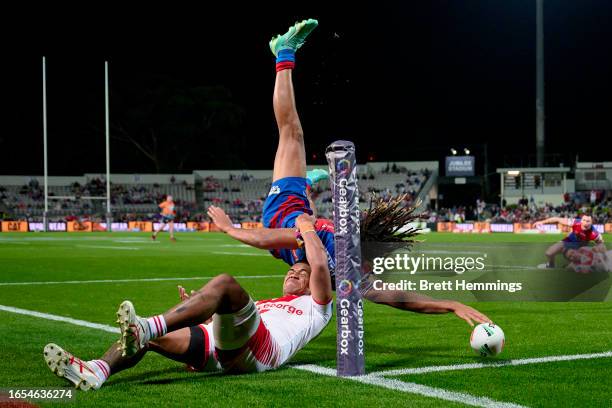 Dominic Young of the Knights scores a try during the round 27 NRL match between St George Illawarra Dragons and Newcastle Knights at Netstrata...