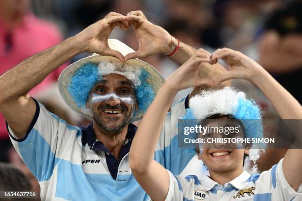 Argentina's supporters wearing face paint in national colours gesture from the stands before the France 2023 Rugby World Cup Pool D match between...
