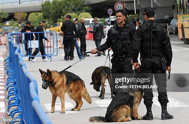 Tunisian policemen with dogs man a checkpoint at the Tunis-Carthage airport to keep Salafists away from the building on April 4, 2013 after radical...