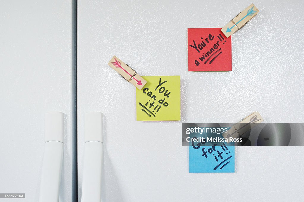 Hand written notes posted on a refrigerator