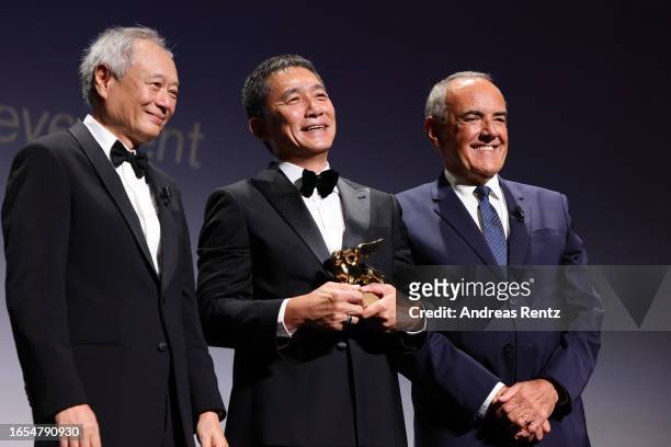 Ang Lee, Tony Leung Chiu-Wai and director of the festival Alberto Barbera attend the Golden Lion For Lifetime Achievement Award Ceremony at the 80th...