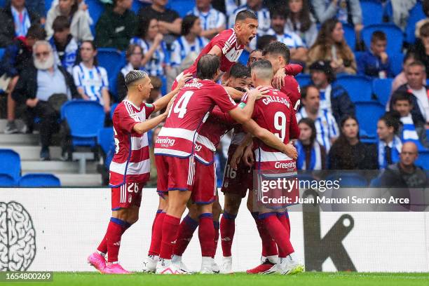 Granada players celebrate after Robin Le Normand of Real Sociedad scores an own goal during the LaLiga EA Sports match between Real Sociedad and...