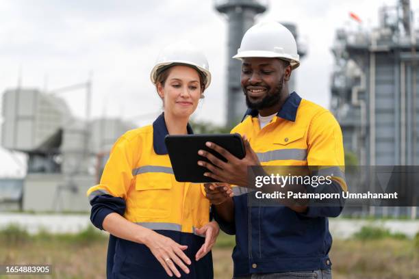 highly skilled engineers is depicted diligently at work, using digital tablet, collaboratively advancing the industry through collective expertise. serves as a powerful tool for innovation and intelligence. power of data analysis. - result stock pictures, royalty-free photos & images