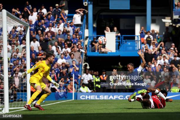 Raheem Sterling of Chelsea is tackled by Ola Aina of Nottingham Forest during the Premier League match between Chelsea FC and Nottingham Forest at...