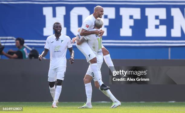 John Brooks of TSG 1899 Hoffenheim celebrates with teammate Wout Weghorst after scoring the team's first goal during the Bundesliga match between TSG...