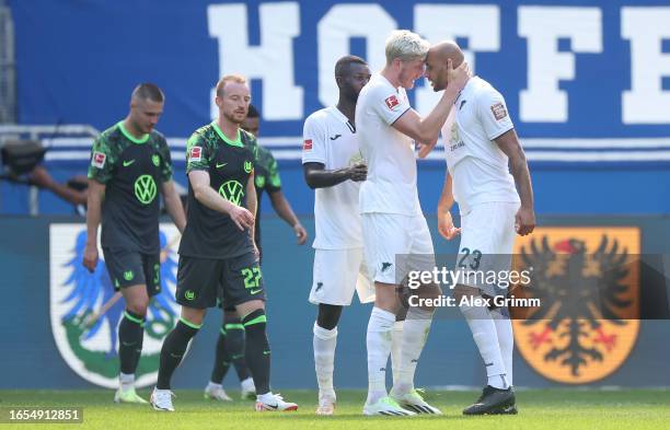 John Brooks of TSG 1899 Hoffenheim celebrates with teammate Wout Weghorst after scoring the team's first goal during the Bundesliga match between TSG...