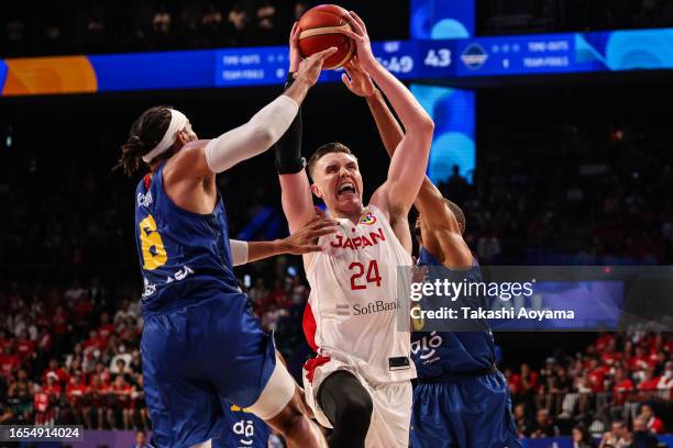 Joshua Hawkinson of Japan drives to the basket against Patrick Lima and Ivan Almeida of Cape Verde during the FIBA Basketball World Cup...