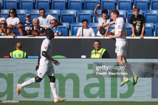 Maximilian Beier of TSG 1899 Hoffenheim celebrates with teammate after scoring the team's second goal during the Bundesliga match between TSG...