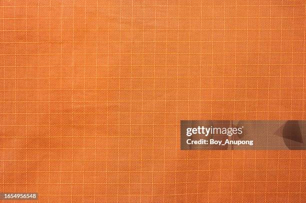 full frame shot of orange nylon texture and background. - water repellent stock pictures, royalty-free photos & images