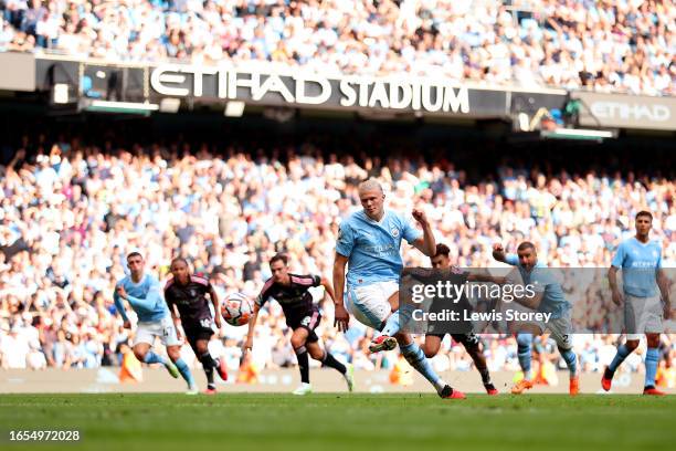 Erling Haaland of Manchester City scores a penalty for the team's fourth goal during the Premier League match between Manchester City and Fulham FC...