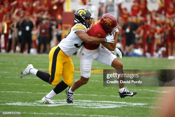 Linebacker Kyler Fisher of the Iowa Hawkeyes tackles wide receiver Jayden Higgins of the Iowa State Cyclones as he rushes for yards in the first half...