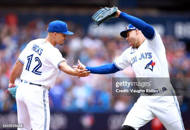 George Springer of the Toronto Blue Jays celebrates with Jordan Hicks following a win against the Kansas City Royals at Rogers Centre on September...