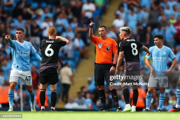 Referee Michael Oliver awards Manchester City a 3rd goal after a VAR review during the Premier League match between Manchester City and Fulham FC at...