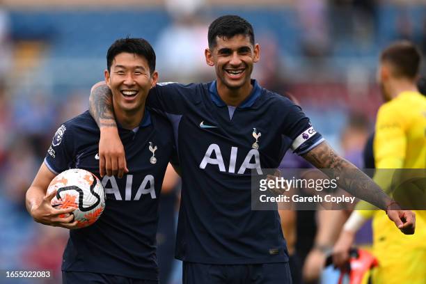 Heung-Min Son of Tottenham Hotspur celebrates with teammate Cristian Romero as he carries the matchball after scoring a hat-trick after the Premier...