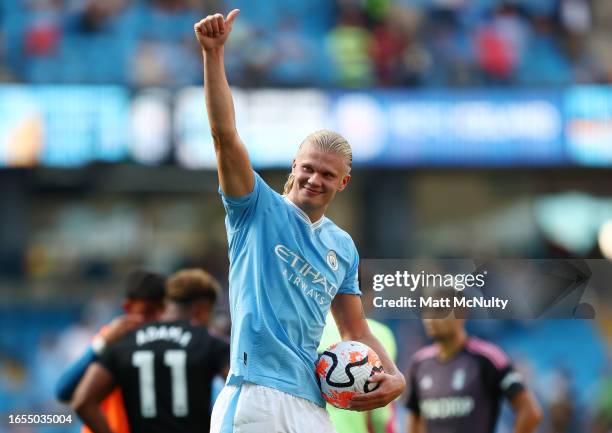 Erling Haaland of Manchester City gives a thumbs up to fans at full time holding his hat-trick ball following the Premier League match between...