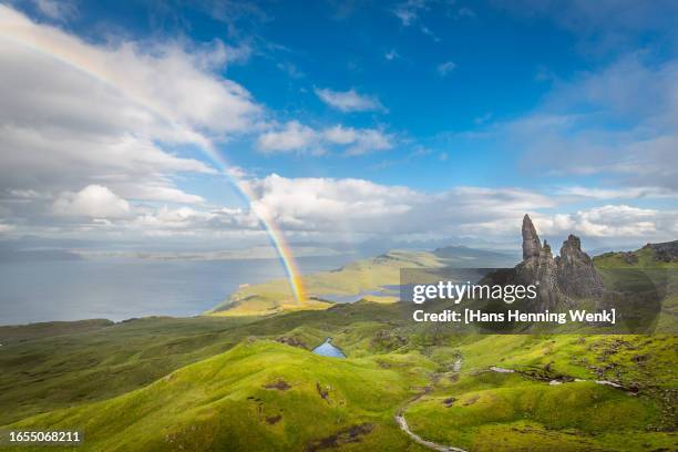 rainbow and dramatic cloudscape over the old man of storr, skye, scotland - old man of storr stock pictures, royalty-free photos & images