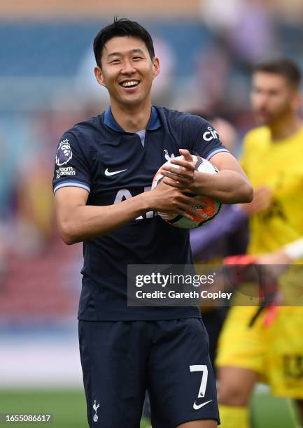 Heung-Min Son of Tottenham Hotspur applauds the fans as he carries the matchball after scoring a hat-trick after the Premier League match between...