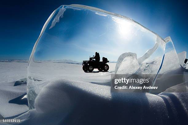 explorer drives an atv - lake baikal stock pictures, royalty-free photos & images