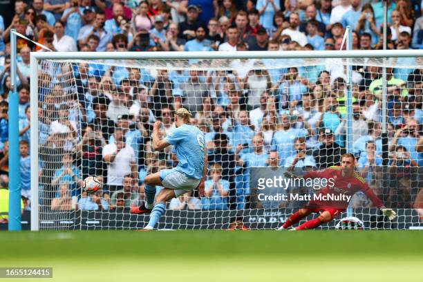 Erling Haaland of Manchester City scores the team's fourth goal from the penalty spot to seal a hat-trick during the Premier League match between...