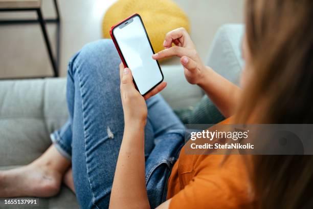 woman is using a mobile phone - hand holding phone stock pictures, royalty-free photos & images