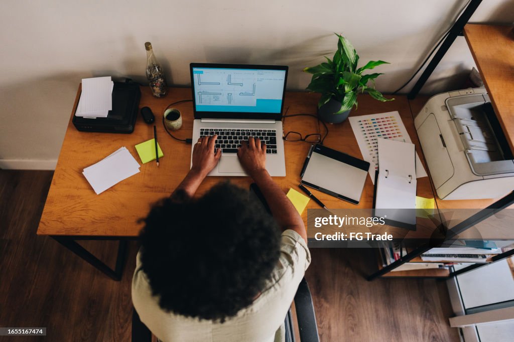 High angle view of a mature woman working with laptop at home