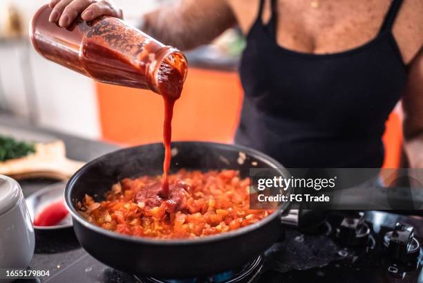 mature woman preparing sauce at home - salsa sauce stock pictures, royalty-free photos & images