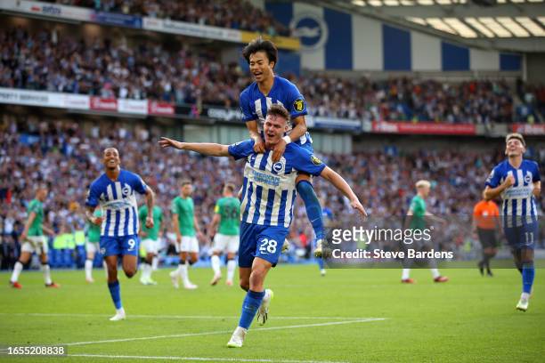 Evan Ferguson of Brighton & Hove Albion celebrates with teammate Kaoru Mitoma after scoring his and the team's third goal during the Premier League...