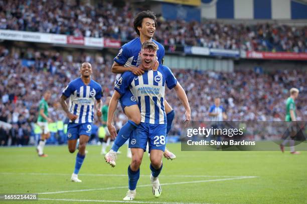 Evan Ferguson of Brighton & Hove Albion celebrates with teammate Kaoru Mitoma after scoring his and the team's third goal during the Premier League...