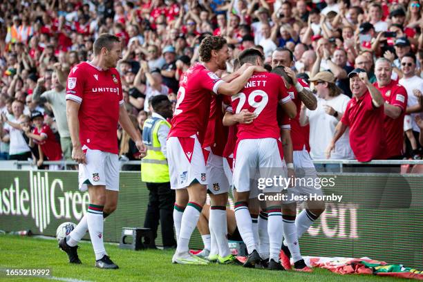 Elliot Lee of Wrexham AFC celebrates scoring their side's second goal with team-mates during the Sky Bet League Two match between Wrexham and...