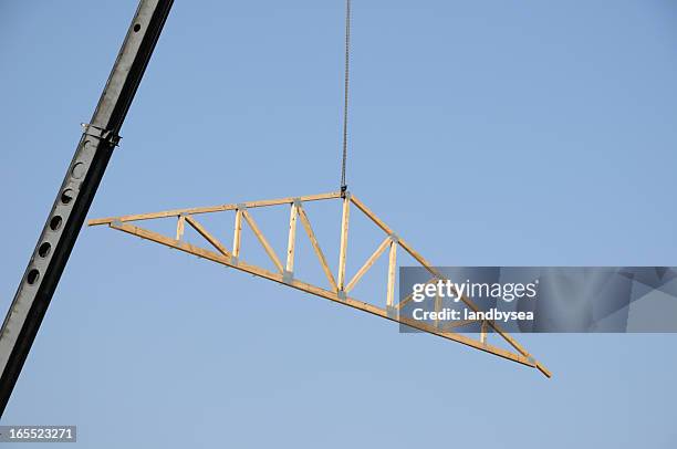 roof truss being hoisted by crane - roof truss stock pictures, royalty-free photos & images