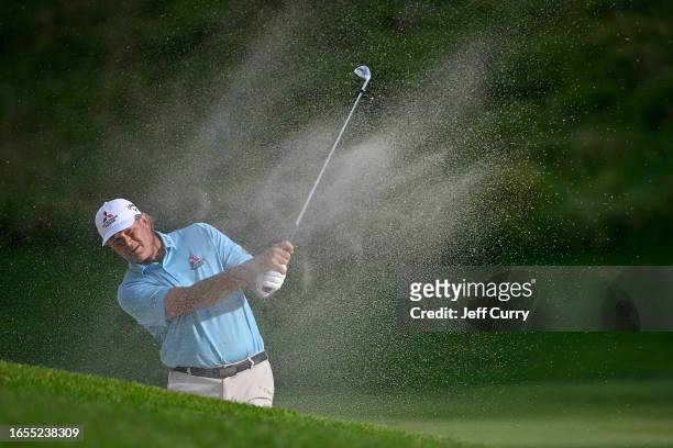 Retief Goosen of South Africa hits his shot out of a bunker on the 17th hole during the second round of the Ascension Charity Classic at Norwood...