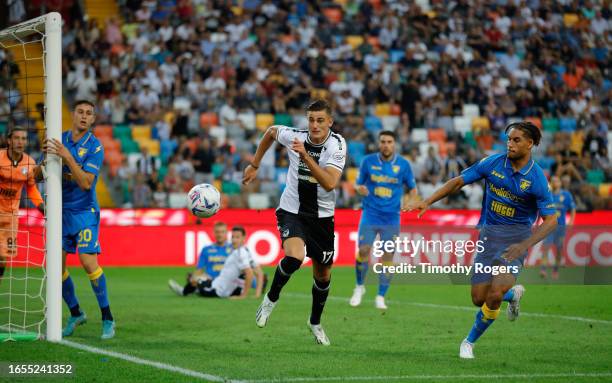 Lorenzo Lucca of Udinese gives chase to the ball under pressure from Anthony Oyono of Frosinone during the Serie A TIM match between Udinese Calcio...