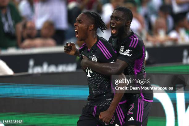 Mathys Tel of Bayern Munich celebrates with teammate Dayot Upamecano after scoring the team's second goal during the Bundesliga match between...