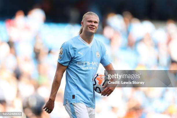 Erling Haaland of Manchester City carries the matchball after scoring a hat-trick during the Premier League match between Manchester City and Fulham...