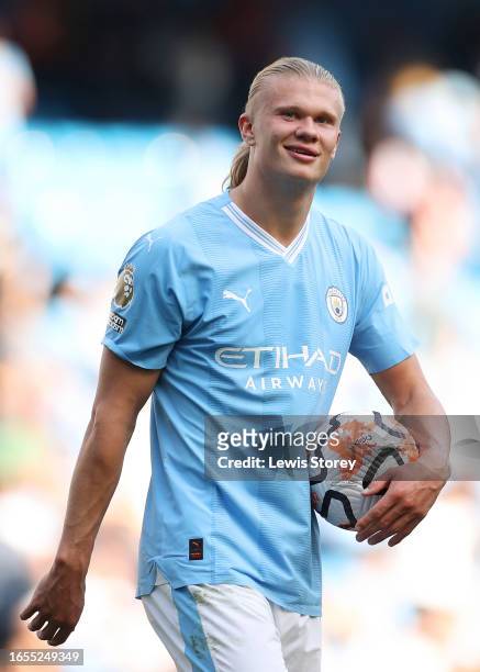 Erling Haaland of Manchester City carries the matchball after scoring a hat-trick during the Premier League match between Manchester City and Fulham...
