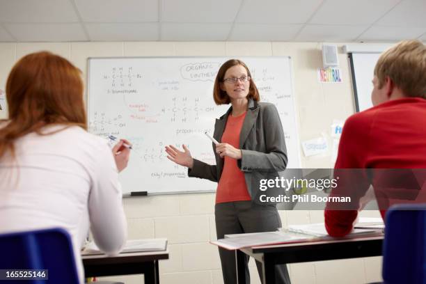 teacher at whiteboard in science class - newport wales stock pictures, royalty-free photos & images